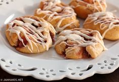 a white plate topped with pastries covered in icing