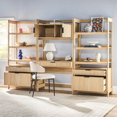 a room with a desk, chair and bookcases on the shelves in it