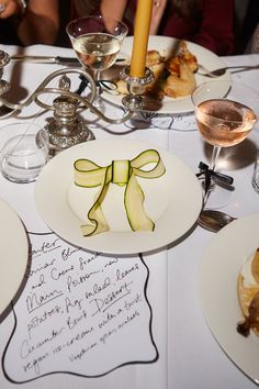 a table topped with plates and glasses filled with food