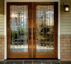 two doors with glass on the side of a house