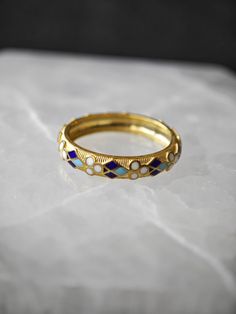 Traditional motifs are commomly used in enamel craftsmanship. We wanted to use an elegant and minimalistic motif on our ring. The ring has four enamel colors : Turquoise, Navy Blue, Black and Ancient White. The ring is 925 Sterling Silver with 18k gold plating. (We do offer different plating options, please see the variations during your purchase.)  If you would like to have your ring with different enamel colors, please message us. We would be so happy to do your custom work. Thank you so much for reading. Victorian Luxury Enamel Ring For Formal Occasions, Yellow Gold Enamel Stackable Rings, Blue Hallmarked Enamel Ring, Heirloom Enamel Ring Jewelry, Heirloom Enamel Ring, Yellow Gold Enamel Jewelry With Inlay, Yellow Gold Jewelry With Enamel Inlay, Round Enamel Ring With Inlay, Heirloom Enamel Ring For Anniversary