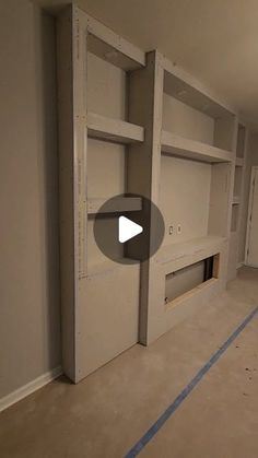 an empty room with some shelves in the middle and no doors on the other side