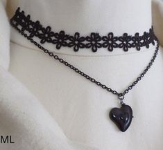 Two strand choker necklace, featuring black lace and recycled black coated chain with a black ceramic heart pendant. Perfect for festive season celebrations. Measurements lace collar - approx 37 cms chain- approx. 43 cms heart pendant - 2 X 2 cm The necklace is adjustable, extension chain is attached. Will be sent in a box as seen in the photo. Shipping All items will be sent by Royal Mail Standard /Hermes (domestic) and Royal Mail International Standard to other destinations. Please note! Royal Black Choker For Halloween Gift, Emo Choker Necklaces For Valentine's Day, Emo Choker Necklace For Valentine's Day, Black Emo Choker Necklace, Emo Valentine's Day Choker Necklace, Valentine's Day Emo Choker Necklace, Emo Black Choker Necklace, Black Heart Pendant Choker, Elegant Black Heart Pendant Choker