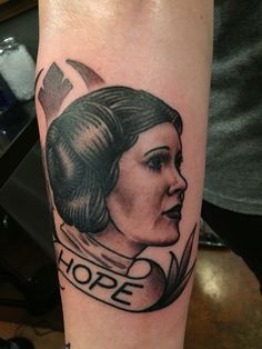 a woman's arm with a tattoo on it that says hope and an arrow above her head