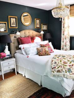 a bed room with a neatly made bed and a chandelier