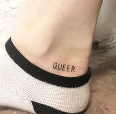 a woman's foot with the word queen written on it, in black ink