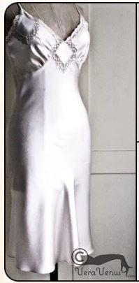 a white dress is on display in front of a mannequin