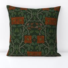 a green and orange pillow with flowers on it