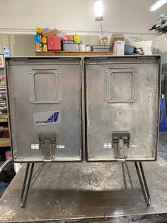 two metal cabinets sitting on top of a table