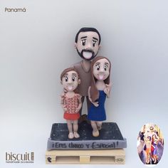 a family figurine sitting on top of a book next to a white background