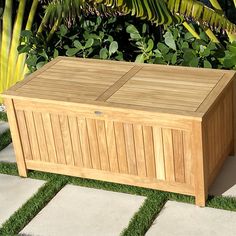 a large wooden box sitting on top of grass