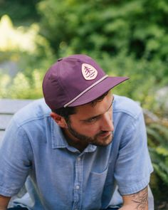 Made from sustainable, lightweight and breathable nylon material, this hat ensures optimal comfort, allowing your head to stay cool and protected. Featuring the iconic Treehouse Point emblem, move about the world with a memento of your time in the trees. 100% Nylon Eggplant color Woven Treehouse Point icon patch Plastic snapback closure Breathable interior mesh sweatband Casual Waterproof Hats For Outdoor, Casual Waterproof Outdoor Hat, Casual Adjustable Waterproof Hats, Casual Durable Hat With Curved Brim, Packable Outdoor Cap, Packable Cap For Outdoor, Lightweight Waterproof Travel Hat, Casual Curved Brim Durable Hat, Lightweight Outdoor Snapback Cap