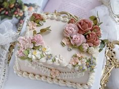 a heart shaped cake sitting on top of a table next to a lace doily