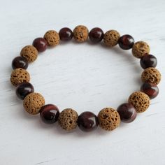 Unisex stretch bracelet combines red tiger's-eye and brown lava beads for an interesting addition to any wardrobe. Great gift for him or her. Casual Brown Stretch Bracelet With Natural Stones, Casual Brown Stretch Bracelet For Healing, Shambala Bracelet, Lava Beads, Red Tigers Eye, Beads Bracelet Design, Bracelet Design, Lava Bead, Aromatherapy Diffusers