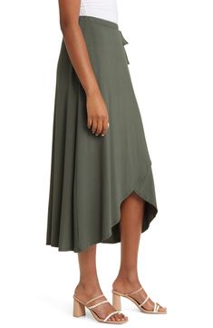 A sleek solid hue brings versatility to this faux-wrap skirt finished with a charming tie accent at the waist. 27" to 30" length 95% rayon, 5% spandex Machine wash, dry flat Imported Black Wrap Skirt, Olive Skirt, Faux Wrap Skirt, Knit Midi Skirt, Black Midi Skirt, Olive Color, Knit Midi, Wrap Skirt, Midi Skirt