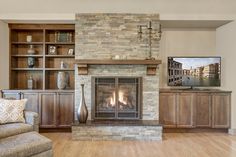 a living room with a fireplace and entertainment center