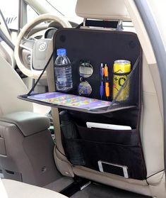 an open car back seat with various items in the backseat and bottles on the floor