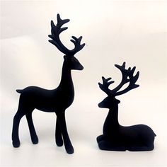 two black deer figurines sitting next to each other