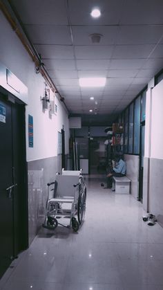 an empty hospital hallway with a wheel chair