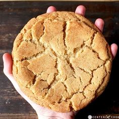 a person holding a cookie in their hand