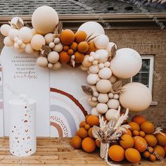 an orange and white display with balloons in front of a brick building on a sunny day