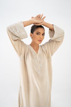 Introducing an exquisite ensemble consisting of a medium-length shirt in a pristine ivory shade, made from pure crepe silk. The shirt is meticulously handworked in self shades, featuring delicate details of resham, kora, and sequins throughout. The front and back of the shirt are fully adorned with this intricate work. To complete the ensemble, it is paired with a matching skinny shalwar, which also features matching work on the bottom. Traditional Hand Embellished Georgette Blouse, Elegant Georgette Blouse With Intricate Embroidery, Unstitched Elegant Hand Embellished Kurta, Unstitched Hand Embellished Elegant Kurta, Elegant Hand Embellished Designer Kurta, Elegant Hand Embellished Kurta, Elegant Hand Embellished Kurta For Wedding, Elegant Chikankari Embroidered Top For Wedding, Elegant Embroidered Georgette Blouse Piece