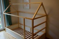 a wooden bunk bed sitting next to a window