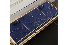 a display case with many different types of jewelry on it's sides, including earrings and rings