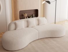 a large white couch sitting on top of a wooden floor