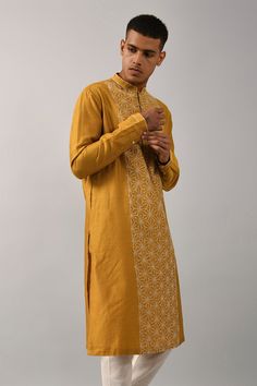 Mustard yellow straight kurta with placement floral motif thread work. Comes with ivory churidar.
Components:2
Embroidered
Neckline:Mandarin Collar
Sleeve Length:Full
Fabric:Chanderi, Cotton
Color:Yellow
Buttoned placket
Stitch lines
Side slits
Cuff sleeves - Aza Fashions Yellow Salwar Kameez With Straight Kurta, Yellow Straight Kurta Salwar Kameez For Seasonal Wear, Yellow Lawn Suit With Zari Work Straight Kurta, Designer Yellow Lawn Suit With Traditional Drape, Festive Mustard Kurta With Resham Embroidery, Yellow Lawn Suit With Traditional Drape For Diwali, Gold Cotton Silk Kurta With Chikankari Embroidery, Traditional Cotton Silk Sherwani With Gota Work, Traditional Yellow Chanderi Sherwani