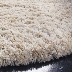 an area rug is shown with black leather on the bottom and white fur on the top