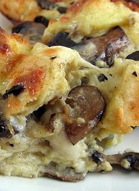 a close up of a plate of food with mushrooms and cheese on it's crust