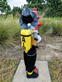 a fire hydrant with a life jacket on it's back and water bottle in the other hand