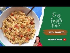 a white bowl filled with pasta on top of a blue and green table cloth next to a