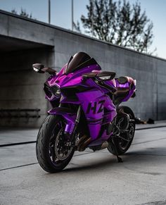 a purple motorcycle parked in front of a building