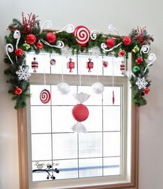 a window decorated for christmas with candy canes and candies