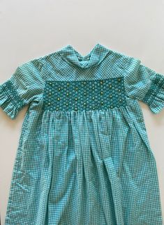 Vintage Style Smocked Dress For Spring, Spring Vintage Smocked Dress With Smocked Bodice, Short Sleeve Gingham Smock Dress, Green Smocked Short Sleeve Dress For Daywear, Spring Vintage Smocked Dress, Vintage Smocked Dress For Spring, Gingham Cotton Smocked Dress With Short Sleeves, Vintage Spring Smocked Dress, Green Cotton Smocked Short Sleeve Dress