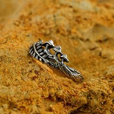 a silver ring sitting on top of a rock