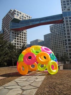 an inflatable object is sitting on the ground near some tall buildings and trees