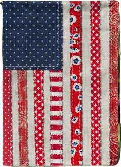 an american flag quilt with red, white and blue strips on it's side