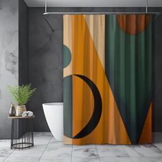 a bathroom with a shower curtain that has an orange and green design on the side