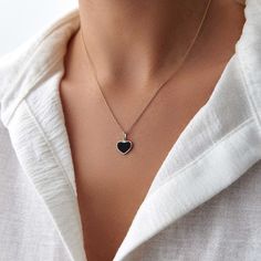 This elegant black heart necklace is crafted with 14k solid gold, embodying timeless beauty and sophistication. Its minimalist design, combined with the finest craftsmanship, makes it a perfect piece for everyday wear or a meaningful gift for a loved one. This necklace is crafted with real 14k solid gold(not plated, not vermeil, not gold filled) You don't need to worry about water, perfume or conditioner contact since real gold doesn't tarnish. The center is hand applied black enamel on top of solid gold for the design purpose, hot applied enamel is the best and most resistant type of application in which enamel and gold bond together over extreme temperatures. This ensures that your piece keeps its beauty for decades to come. You can even wear this piece in water as well. Black Heart Pendant Necklace With Clavicle Chain, Minimalist Jewelry With Heart Charm On Round Pendant, Minimalist Jewelry With Heart Charm Round Pendant, Black Clavicle Chain Necklace For Valentine's Day, Minimalist Heart Cut Jewelry With Polished Finish, Minimalist Jewelry With Heart Charm, Minimalist Heart Necklace With Round Pendant, Minimalist Tarnish Resistant Heart Pendant Jewelry, Minimalist Heart Cut Polished Jewelry