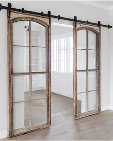 an open door with two mirrors on the wall