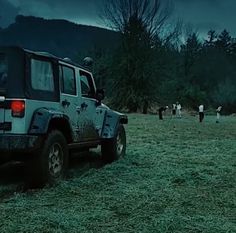 a jeep parked in the middle of a field at night