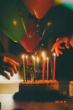 someone lighting candles on a birthday cake