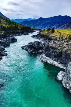 a river running through a lush green valley