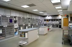 an empty laboratory with lots of cabinets and shelves