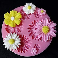 a cake decorated with flowers on top of a pink plate