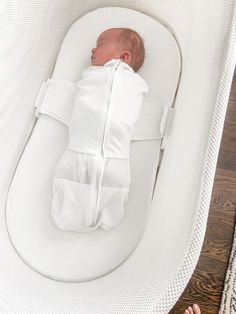 a baby is sleeping in a white crib