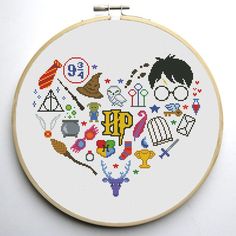 a cross stitch heart with harry potter symbols